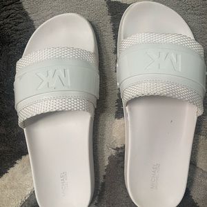 White Michael Kors slides worn for about an hour in like new condition